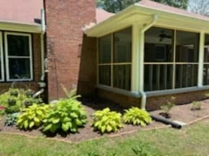 Yellow deck and patio after pressure washing, with clean railings and restored wood surfaces