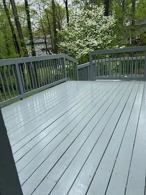 Light gray painted deck with dark gray railings and composite decking boards