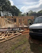 Pressure-treated deck framing with joists and support posts under construction