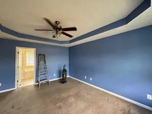 Two-tone interior paint with navy tray ceiling trim and blue walls in empty room