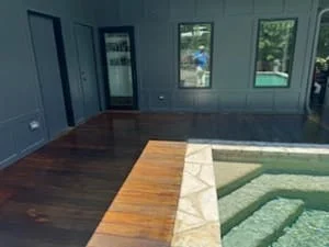 Interior room with blue-gray painted walls, stained wood flooring, and white trim