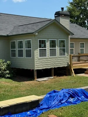 Pressure-treated deck with support posts and framing during construction on raised foundation