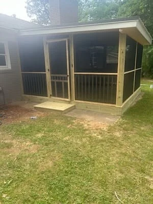 Newly constructed screened porch with wood framing, composite deck, and full-length screens
